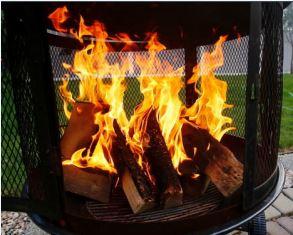 Open Air Burning fire burning in a chiminea on a patio