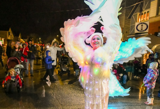 lady in light up costume dancing with children